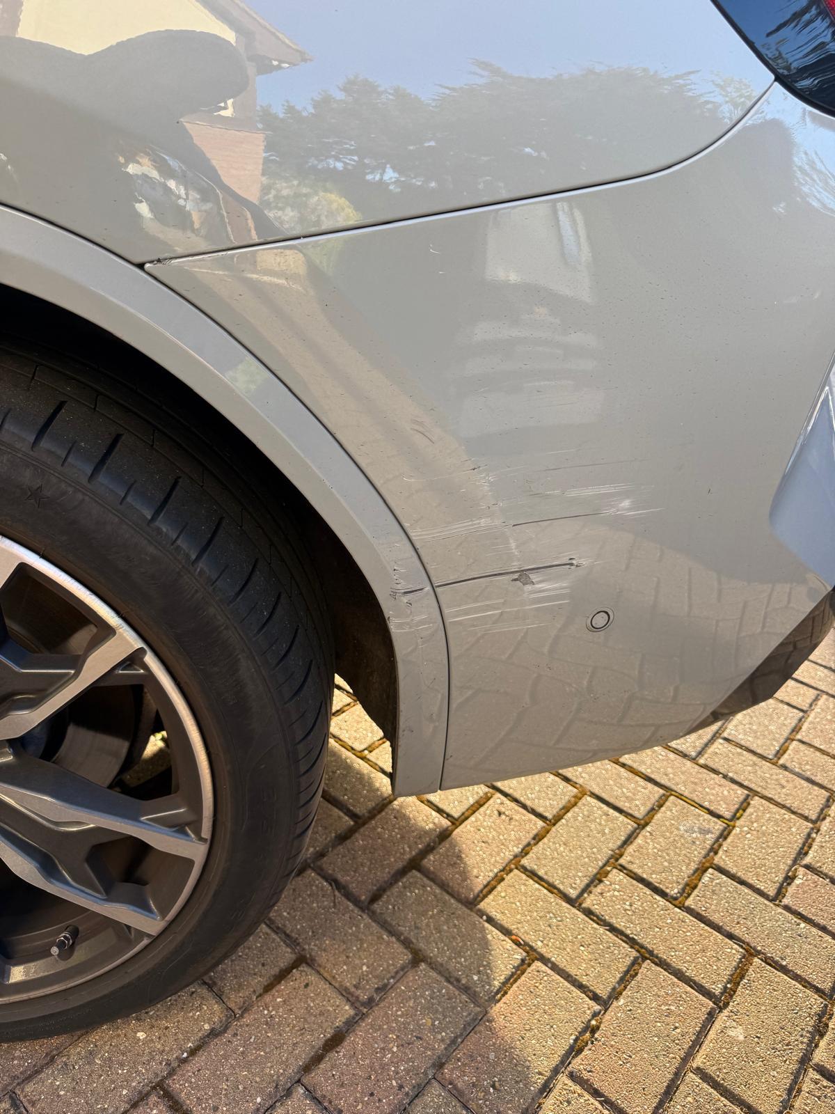 BMW X3 rear quarter scuff repair — Before