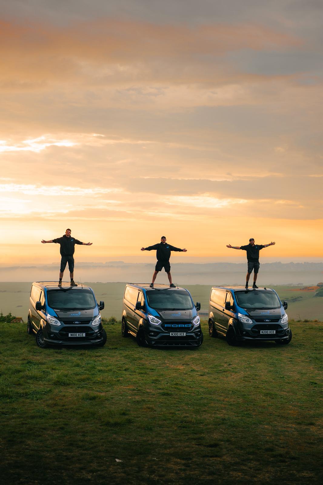 Team standing on the fleet at golden hour